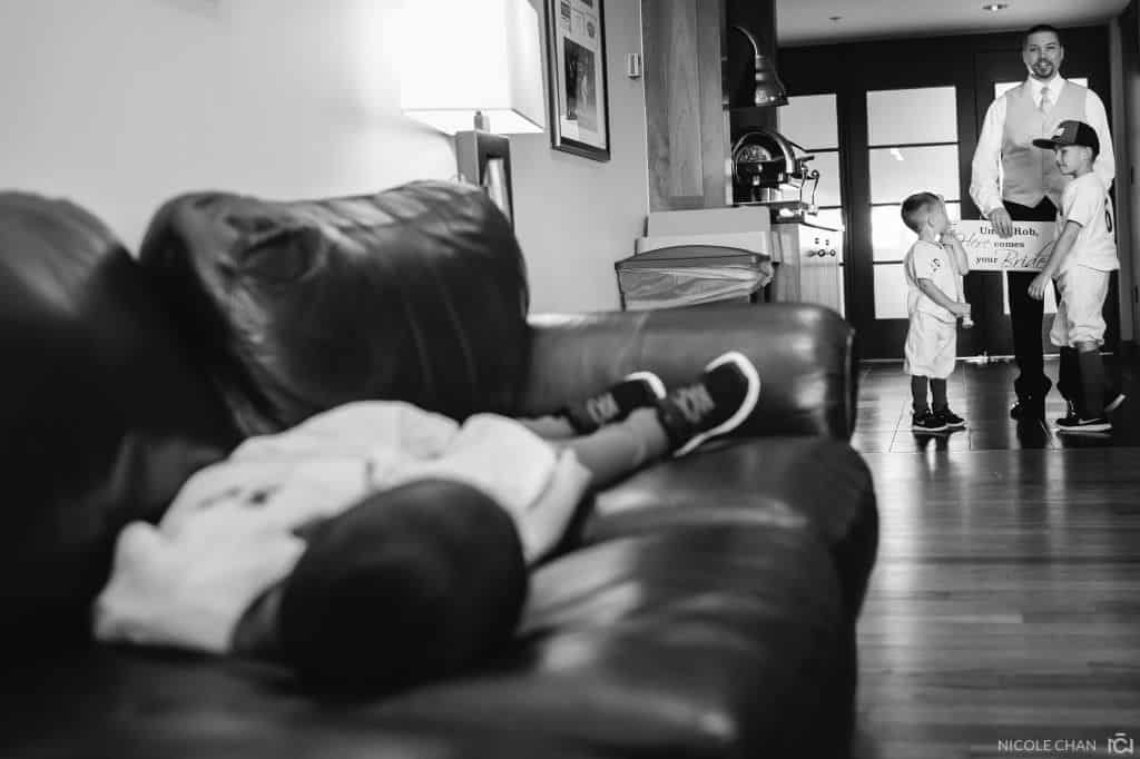 a black and white photo of a man and a child in a living room.