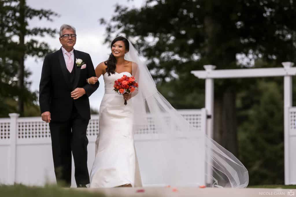 a bride and her father walking down the aisle.