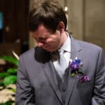 Emotional groom watches his bride walk down the aisle at St. Ignatius Parish, on Boston College’s Campus