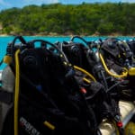 a row of scuba gear sitting on top of a boat.