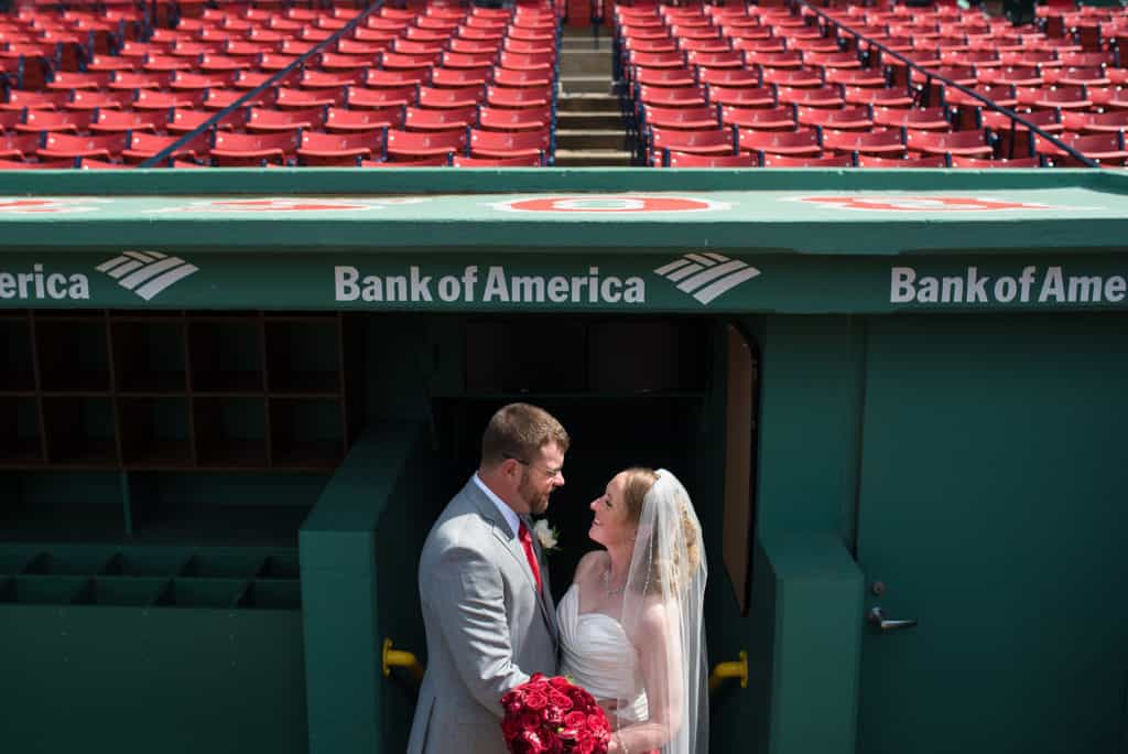 a bride and groom standing in front of a bank of america booth.