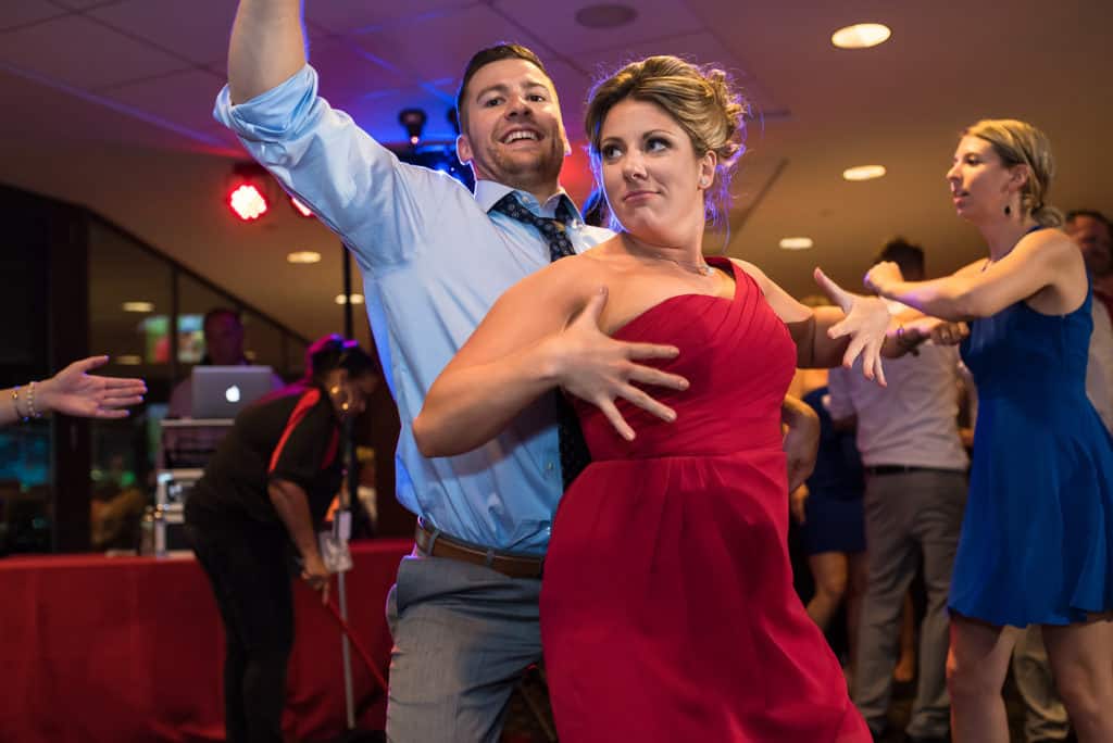 a man and a woman dancing together at a party.