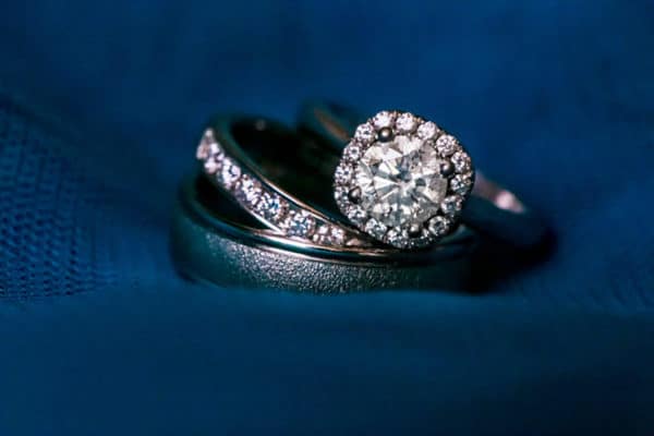 a couple of wedding rings sitting on top of each other.