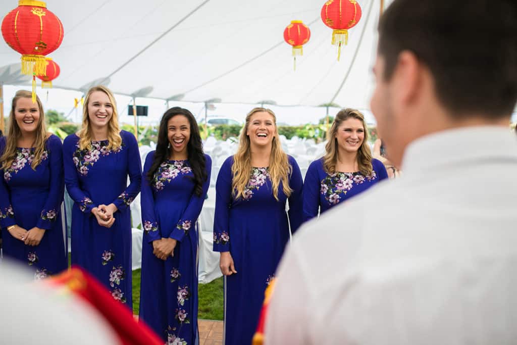a group of women standing next to each other under a tent.