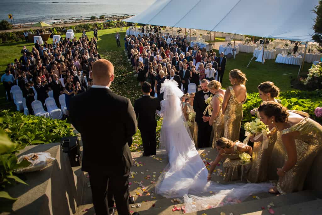 a couple getting married in front of a crowd of people.