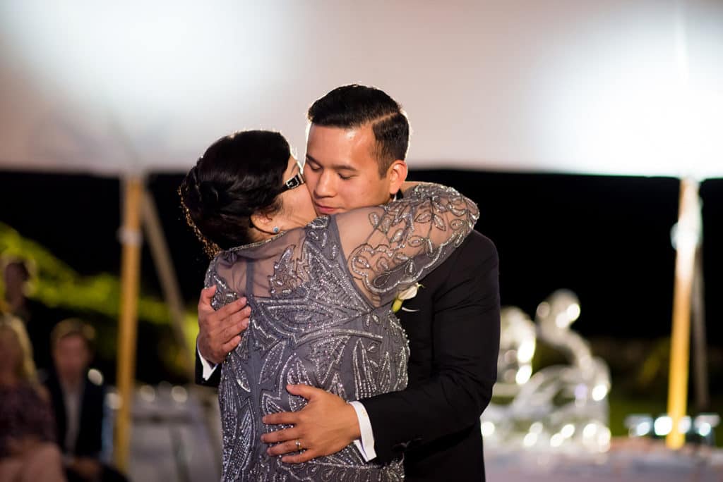 a man and a woman hugging each other on a dance floor.