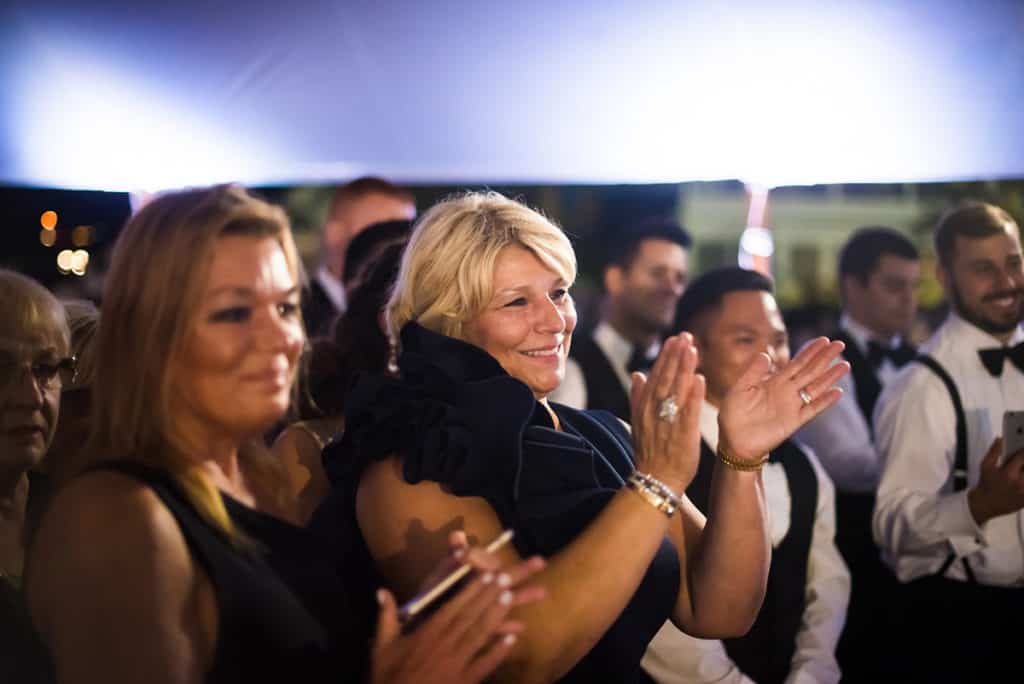 a group of people applauding at a formal event.