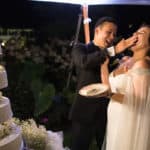 a bride and groom feeding each other a piece of cake.