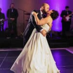 a bride and groom share their first dance.