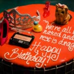 a birthday cake with a tiara and a cell phone.