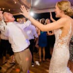 a bride and groom dancing on the dance floor.