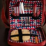 a red, white and blue lunch box with utensils.