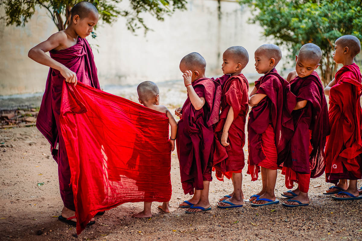 a group of young monks standing next to each other.