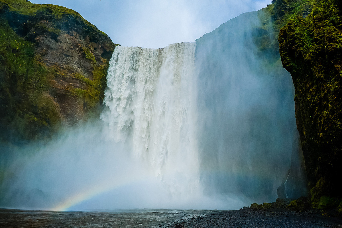 a waterfall with a rainbow in the middle of it.