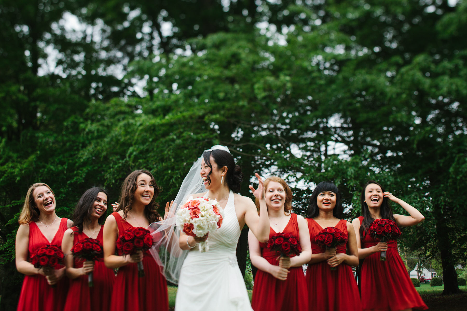 a bride and her bridesmaids laughing together.