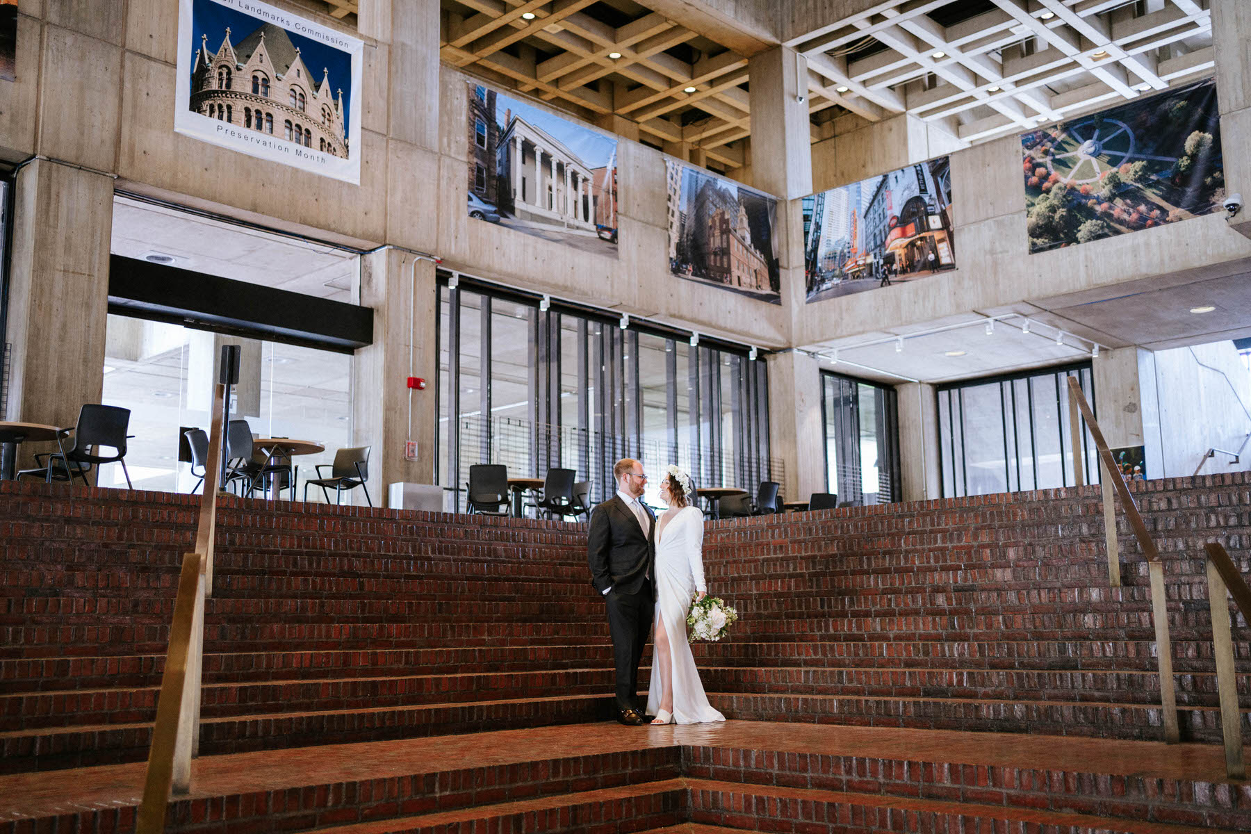 a bride and groom standing on the steps of a building.