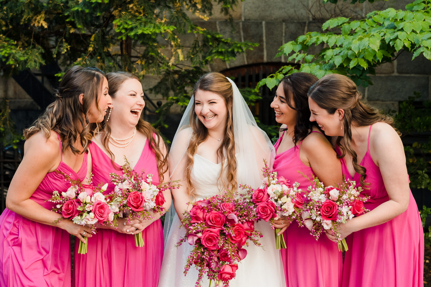 a group of women in pink dresses.