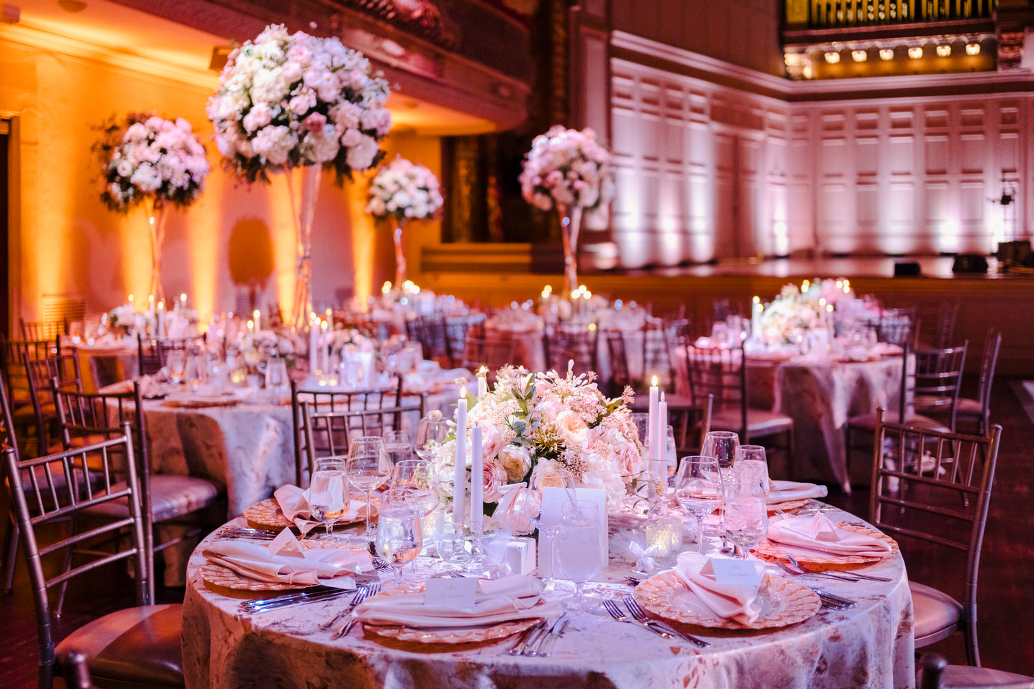 A wedding reception set up in a large ballroom.