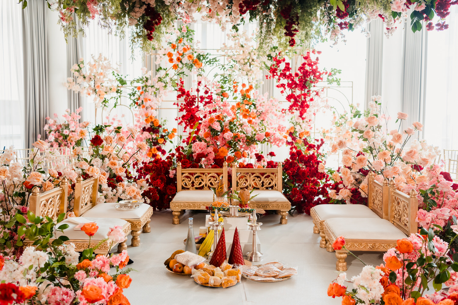 An indian wedding ceremony set up with flowers.