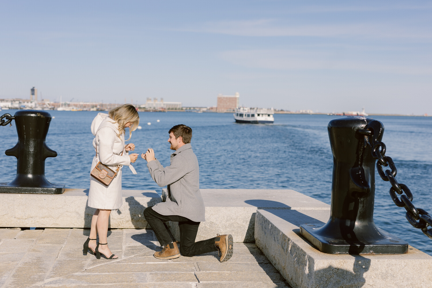 A Boston photographer captures a man proposing on a pier.
