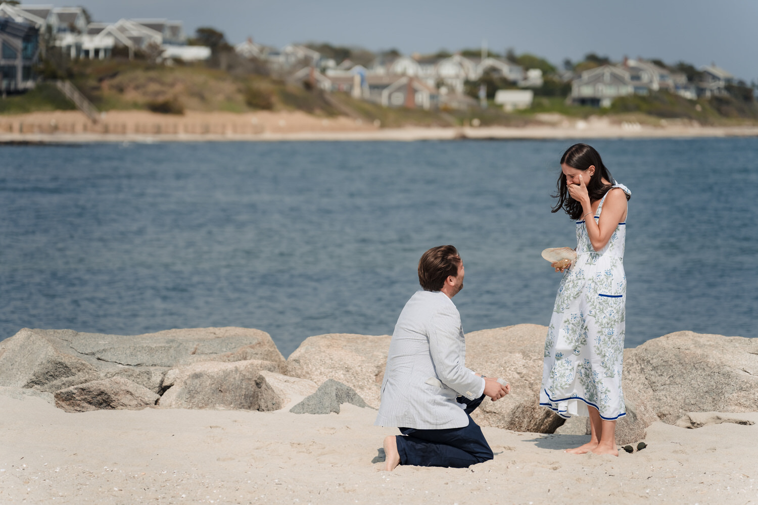 A Boston proposal photographer captures a man proposing to a woman on the beach.