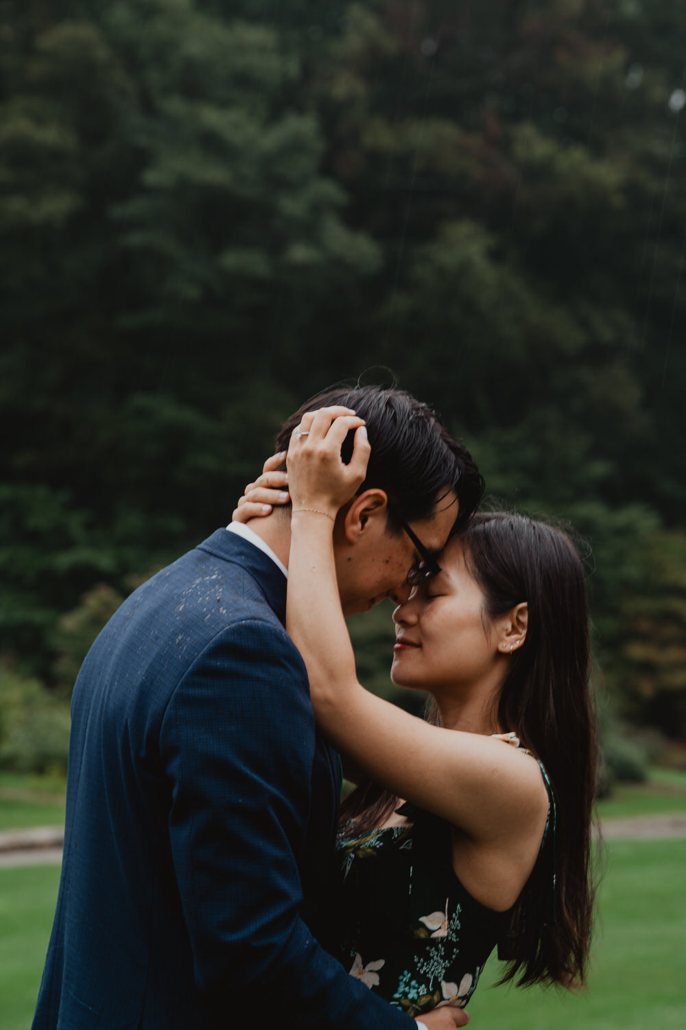 A couple embracing during their Arnold Arboretum engagement session.