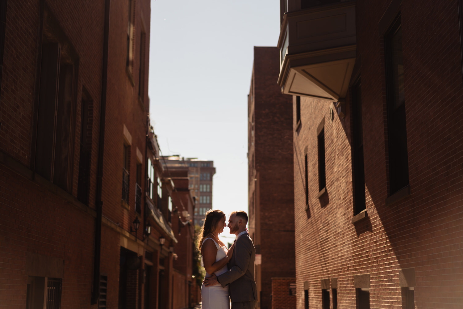 A bride and groom embracing at Boston City Hall wedding.